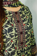 Green and black patterned garment with intricate designs on a plain background