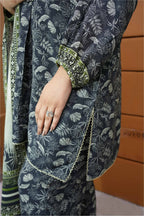 Person wearing a dark blue floral patterned outfit with green accents.
