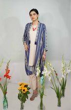 Woman wearing a blue and white patterned outfit with flowers in the foreground