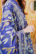 Person wearing a blue floral kimono-style garment with a blurred background