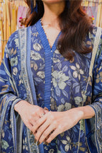 Person wearing a blue floral kimono-style garment with a blurred background