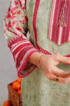 Close-up of a person wearing a traditional outfit with red and white embroidery, holding a basket of oranges.