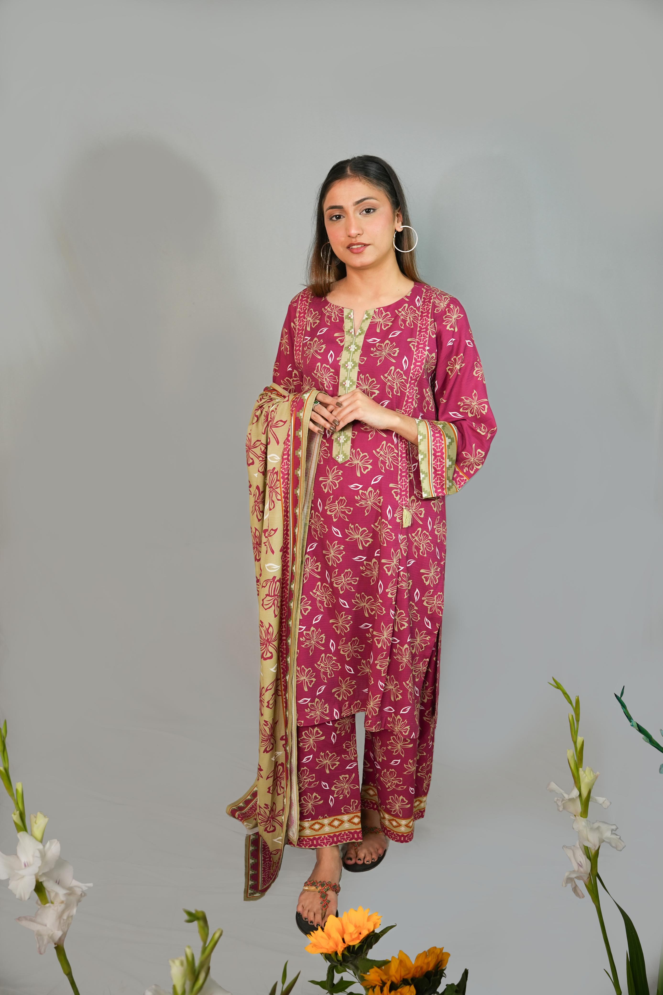Woman wearing a pink traditional outfit with a floral pattern on a gray background