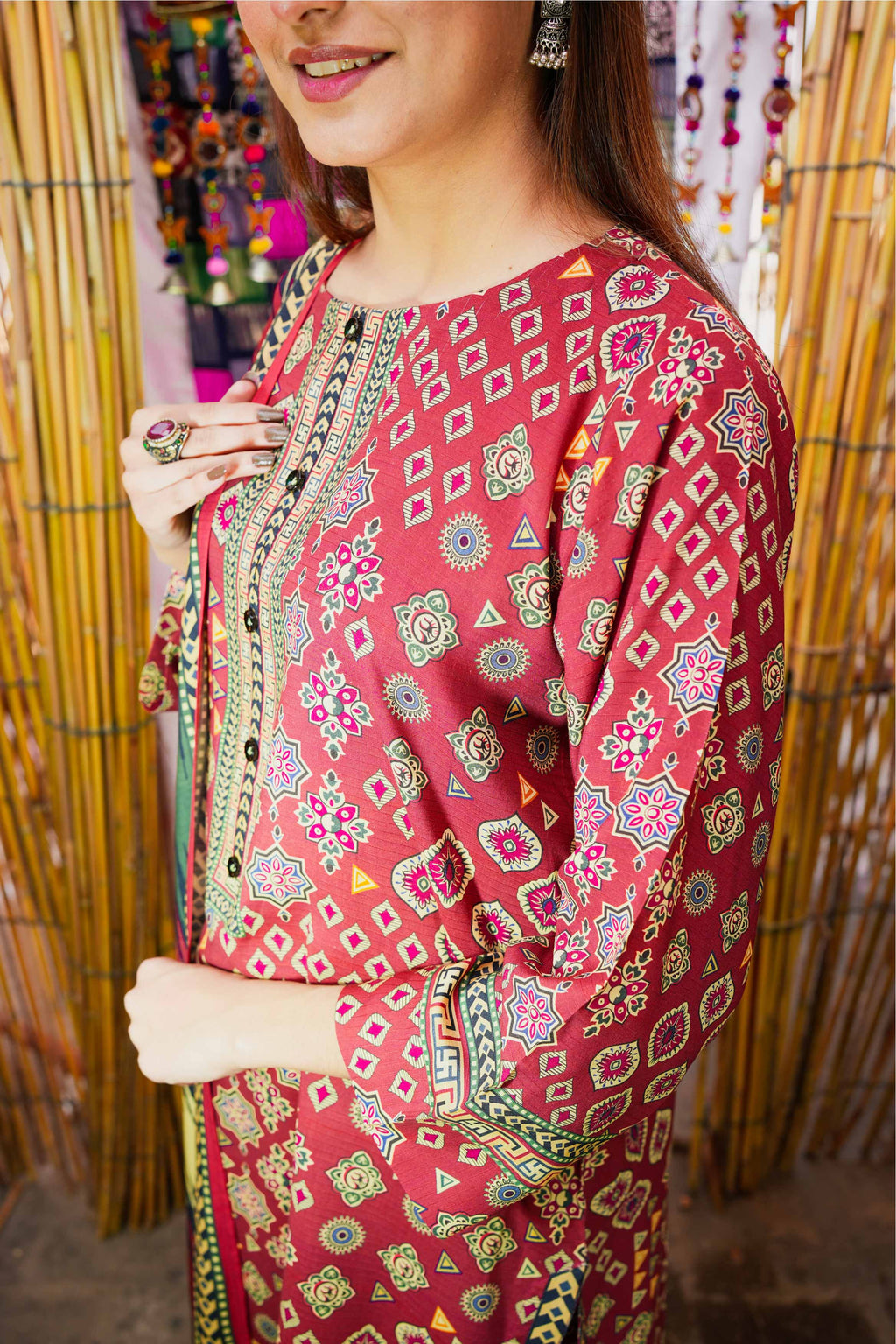 Woman wearing a red patterned dress with a blurred background