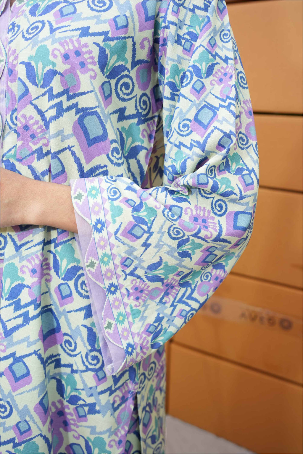 Colorful patterned fabric with geometric shapes on a wooden surface