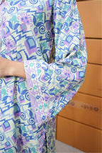 Colorful patterned fabric with geometric shapes on a wooden surface