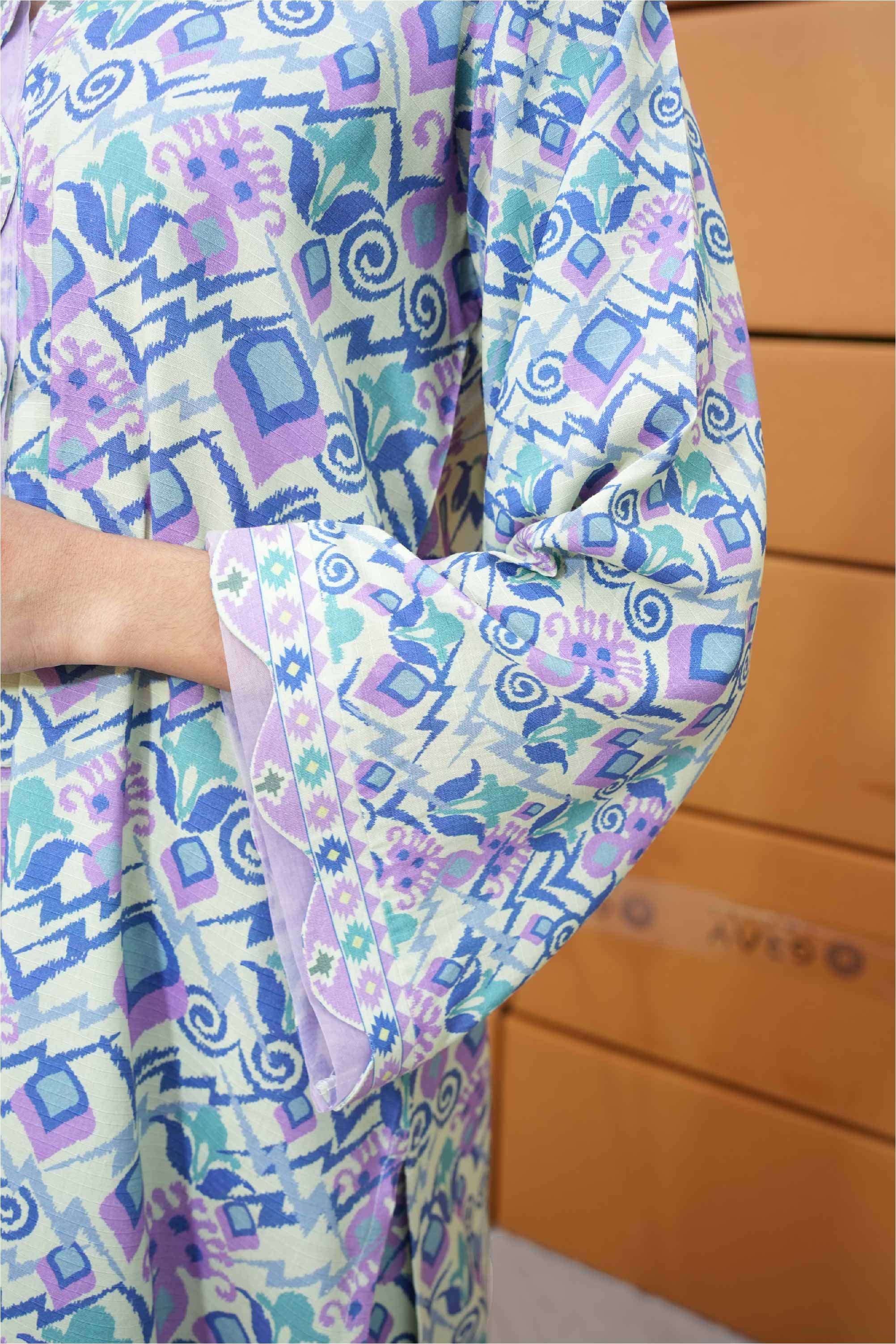 Colorful patterned fabric with geometric shapes on a wooden surface