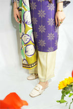 Person wearing a colorful traditional outfit with a white background